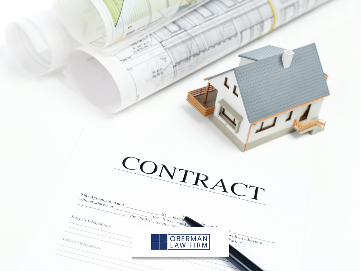 Little house on top of construction contract paperwork