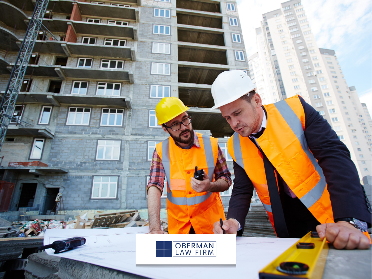Two construction men arguing at a work table