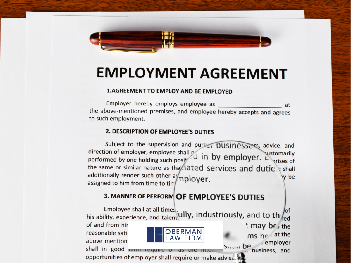photo of an employment agreement with a pen on top ready to sign