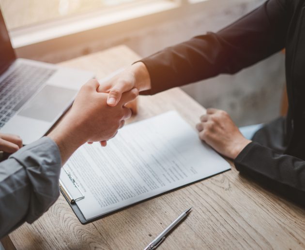 Business negotiations real estate agents women shaking hands with clients after signing property sales contracts giving advice, passing bank approvals and installments, Concept new house moving house.