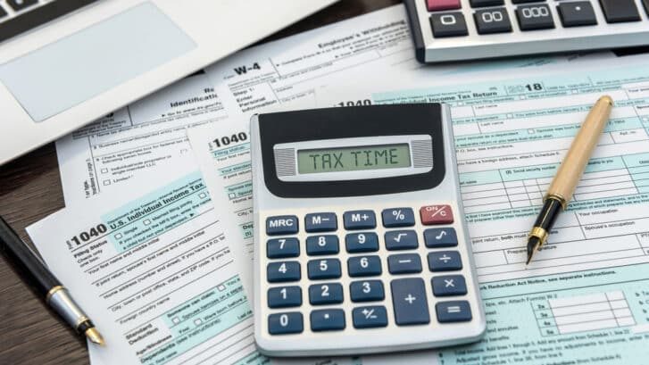 Financial,Time,Tax,Form,With,Laptop,And,Calculator.,Office,Paperwork.