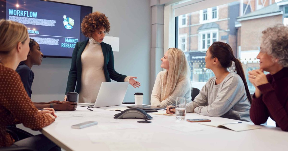 Pregnant,Businesswoman,Leads,Creative,Meeting,Of,Women,Collaborating,Around,Table