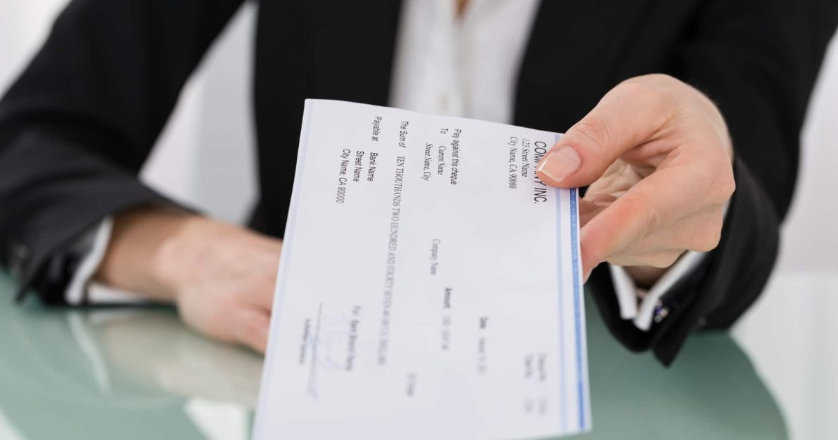 Businesswoman Hand Giving Cheque