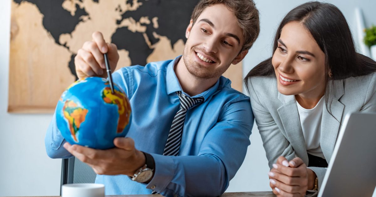 two people holding a globe