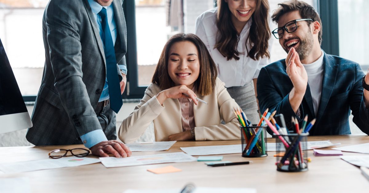 coworkers sitting around table together