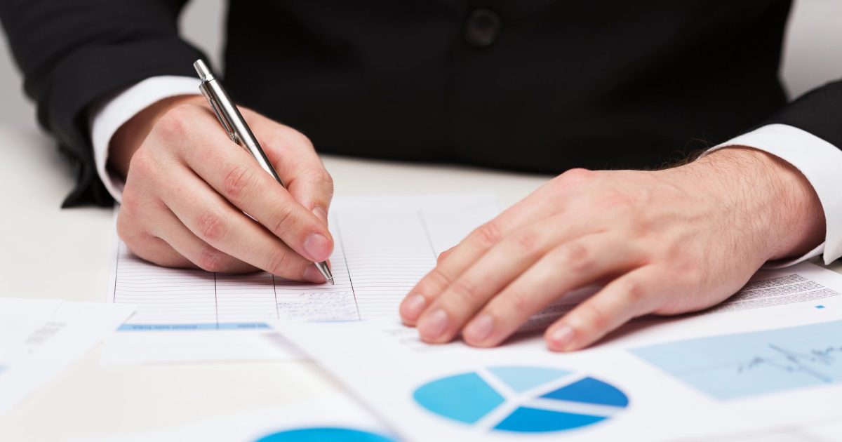 man writing on charts