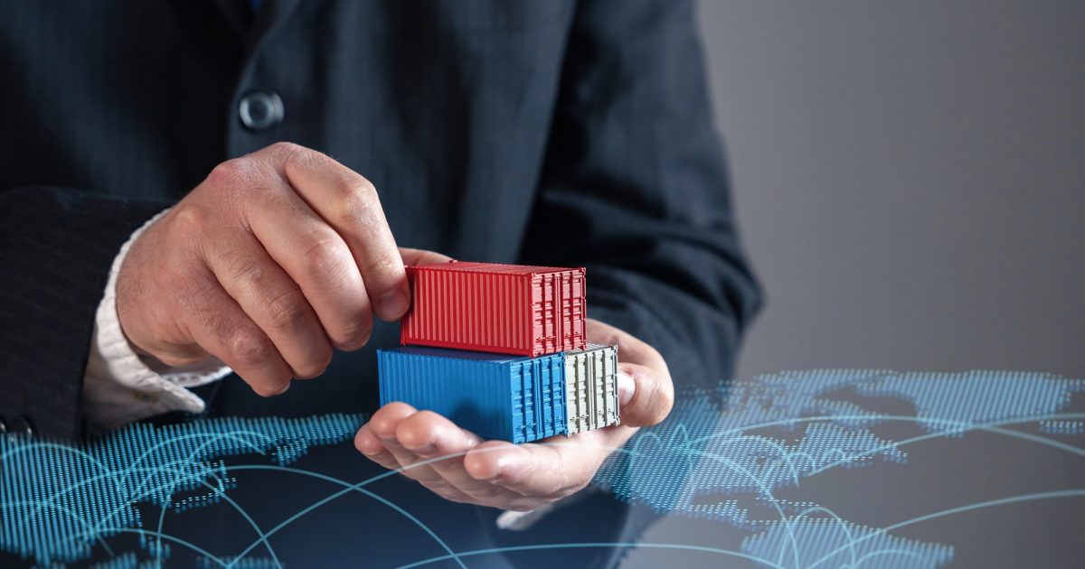 man holding mini shipping containers